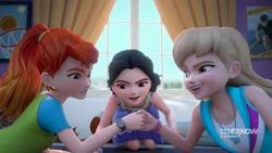 Mia and Stephanie thumb wrestling, with Emma as referee.