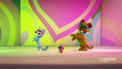 A cat, a parakeet and a dog doing a synchronised dance, not something seen every day.