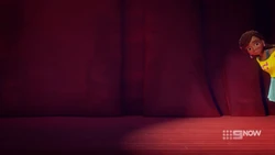 Andrea peeking at the audience from offstage.