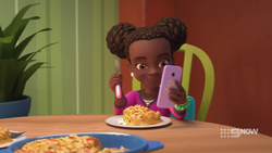 Eating with one hand, using her phone with the other, Miss Junior Phoneaholic 2020.