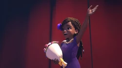 Andrea waves to the audience with her bouquet in hand.