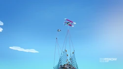 The biplane and Zobo lifting the trash filled net.