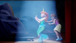 Olivia pushing Mia on stage.