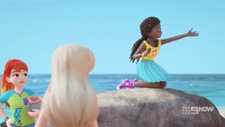 Andrea sees a pile of trash messing up the nice clean beach.