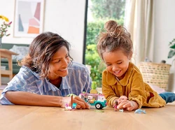 A parent and child playing with the set.