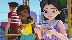 Emma is too distracted by her text chatting to notice Andrea needs her to explain to the boy that she can’t sing.