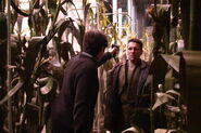 John Lynch holds a gun on Anthony Crivello in a scene from "ALIEN HUNTER."