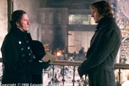 Valjean speaking with Inspector Javert (Geoffrey Rush)