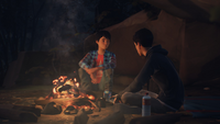 Sean and Daniel are talking at their campfire. ("Roads")