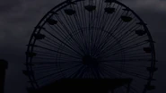 The Ferris wheel turns dark.