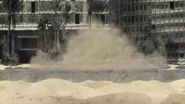 The bucket machine smashes into the desert below.