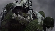 The statues continue to strain the flag pole.