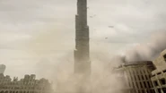 The Burj Khalifa falls into the desert below.