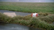 Growing grass obscures one of the airport's signs, formerly used to guide aircraft.