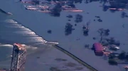 Hurricane Katrina damages the levees, flooding the area.