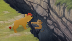 Kion reaches down to save Nala from falling into a rift in the earth.