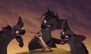 The hyenas gather around a singing Timon