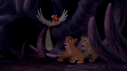 Zazu arrives at the Elephant Graveyard with Mufasa to rescue Simba and Nala.