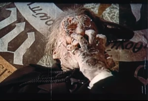 Dracula tearing off his burned face