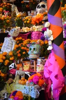 Cempasúchil, alfeñiques and papel picado used to decorate an altar