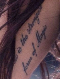 On the inside of her upper right arm are the words “Music is the strongest form of magic”
