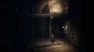 The Nome standing by a lit Lantern in The Nome's Attic.