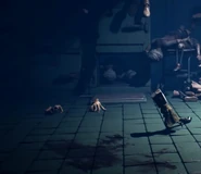 Two hands appearing in the morgue room.