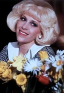 Audrey after watering her flowers during Somewhere That's Green.