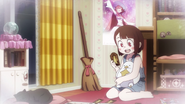 Young Akko reading cards