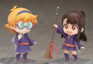 Akko showing off her broom to Lotte.