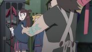 The proprietor stops Akko from touching Shooting Star's cage LWA 03