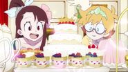 Akko and Lotte looking at cakes presented at Andrew's party LWA 10