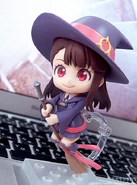 Akko with her broom.