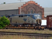 A Damaged Amtrak P42DC is loaded on a flatcar.