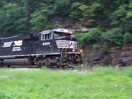 An NS SD60E speeding down the curve with an intermodal in tow.