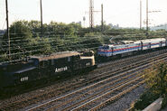 Amtrak #4910 pass an Amtrak GE E60.