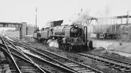 BR Standard Class 9F No. 92079 with an 0-6-0T refueling