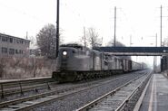 2 PRR GG1s No. 4801 and 4800 hauling a freight train eastward at North Elizabeth in December 1975.