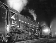 8-3-91 Pere Marquette engine No. 1225 and its Nickel Plate cousin No. 765 en route to Cincinnati, Ohio on Saturday night at Botkins where they hauled a freight train bound for Cincinnati.