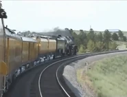 A railfan takes a picture of 3985 from the passenger car.