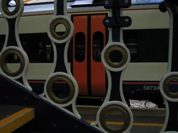 A Class 159, seen through the railings at Exeter St Davids.