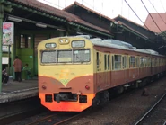 A 103 series EMU on a Depok Express service when using KRL Jabodetabek second livery while passing Gambir railway station, July 2007.