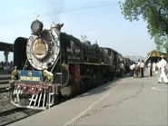 Two India Class YG locomotives are wearing smoke deflectors with faces on them, and lettered “My India is great”.