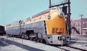 A yellow, streamlined steam locomotive.