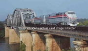 2 P42DC locomotives are crossing a bridge.
