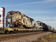 several P42DC locomotives are burned and loaded on flatcars.