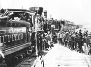 Celebration of completion of the Transcontinental Railroad, May 10, 1869, showing the name Jupiter on the side of the tender.