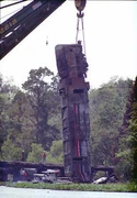 Amtrak #819 with major damage being hauled away by a crane.