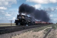 Union Pacific 3985 pulls a freight train, near the end of its career.