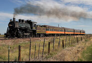 No. 18 leads its beautiful IC-inspired train through a slight curve just north of La Jara, Colorado on its 30 mile run down from Alamosa to Antonito where it will meet the 10am departure of the Cumbres and Toltec Scenic Railroad.